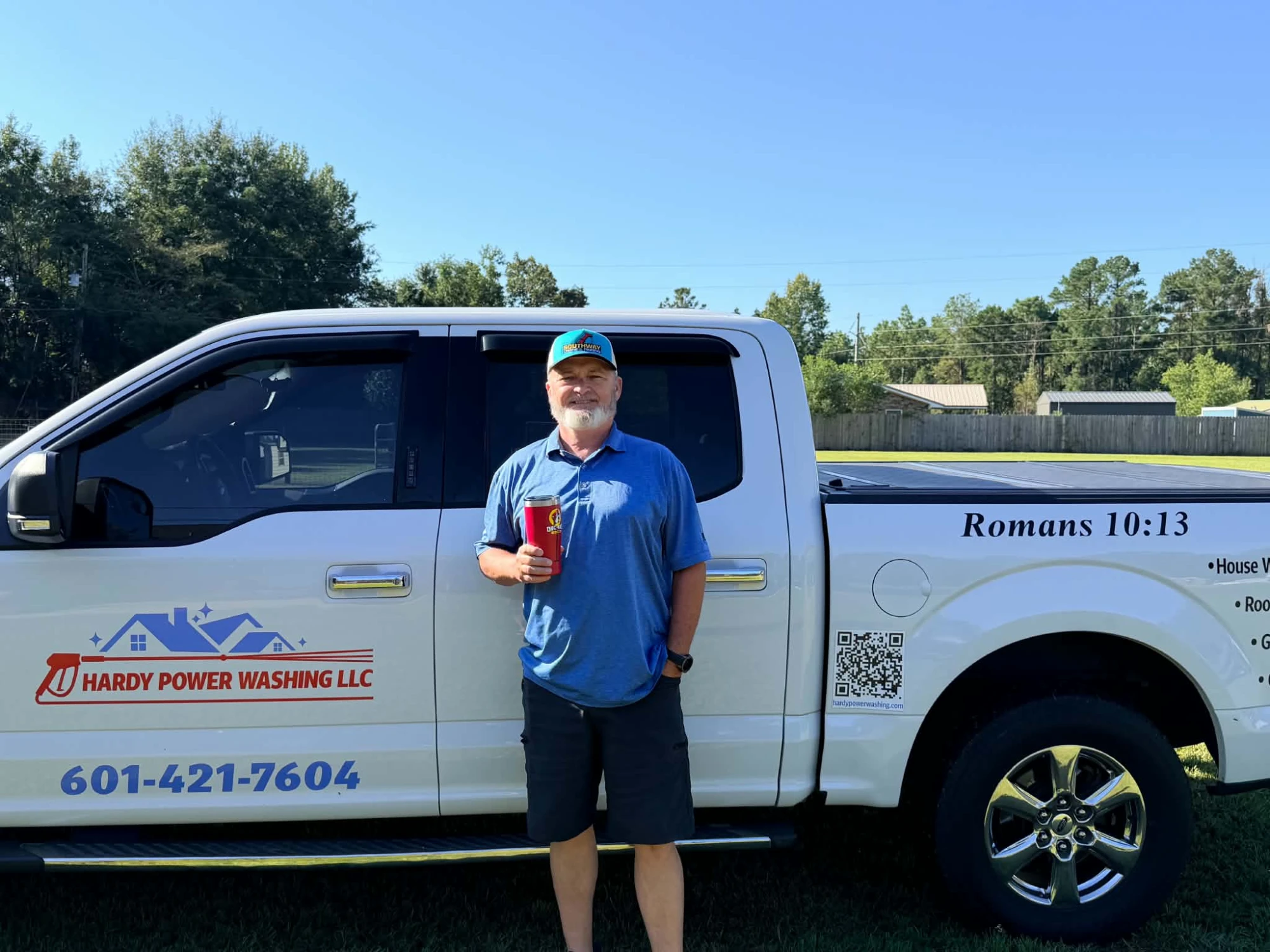 Stephen Hardy, owner of Hardy Power Washing, standing beside his company truck